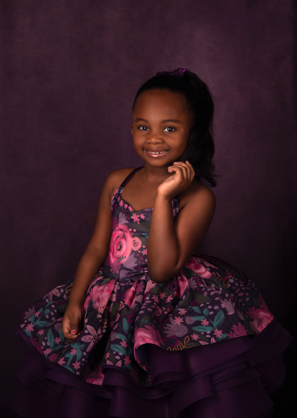 A young girl in a floral dress dances in a studio dallas babysitters