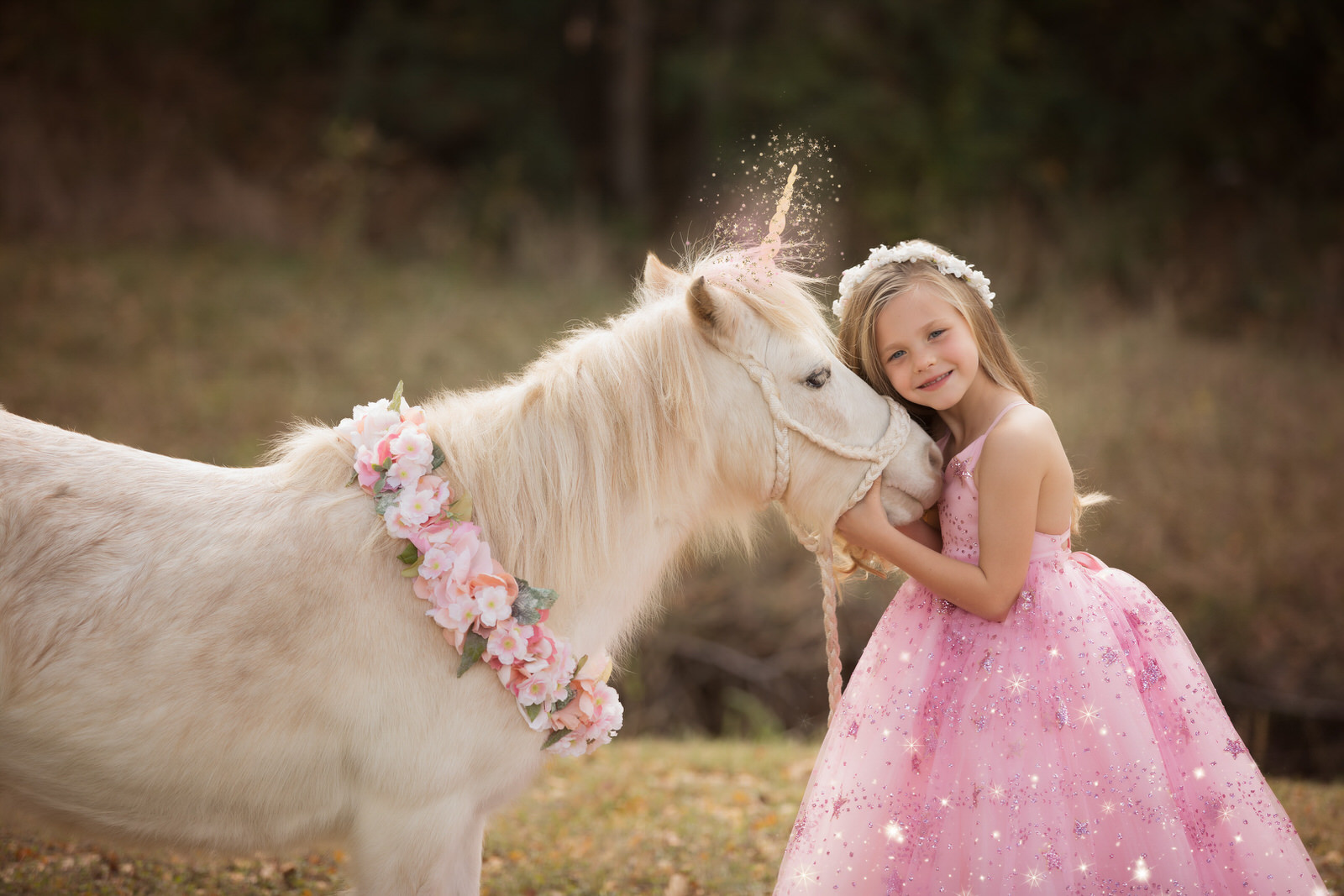 A young girl in a pink dress hugging a unicorn in Dallas Fort Worth Texas