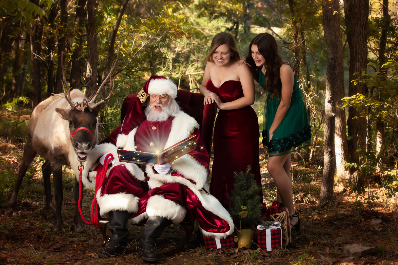 Girls with Santa Claus and Reindeer reading magical book