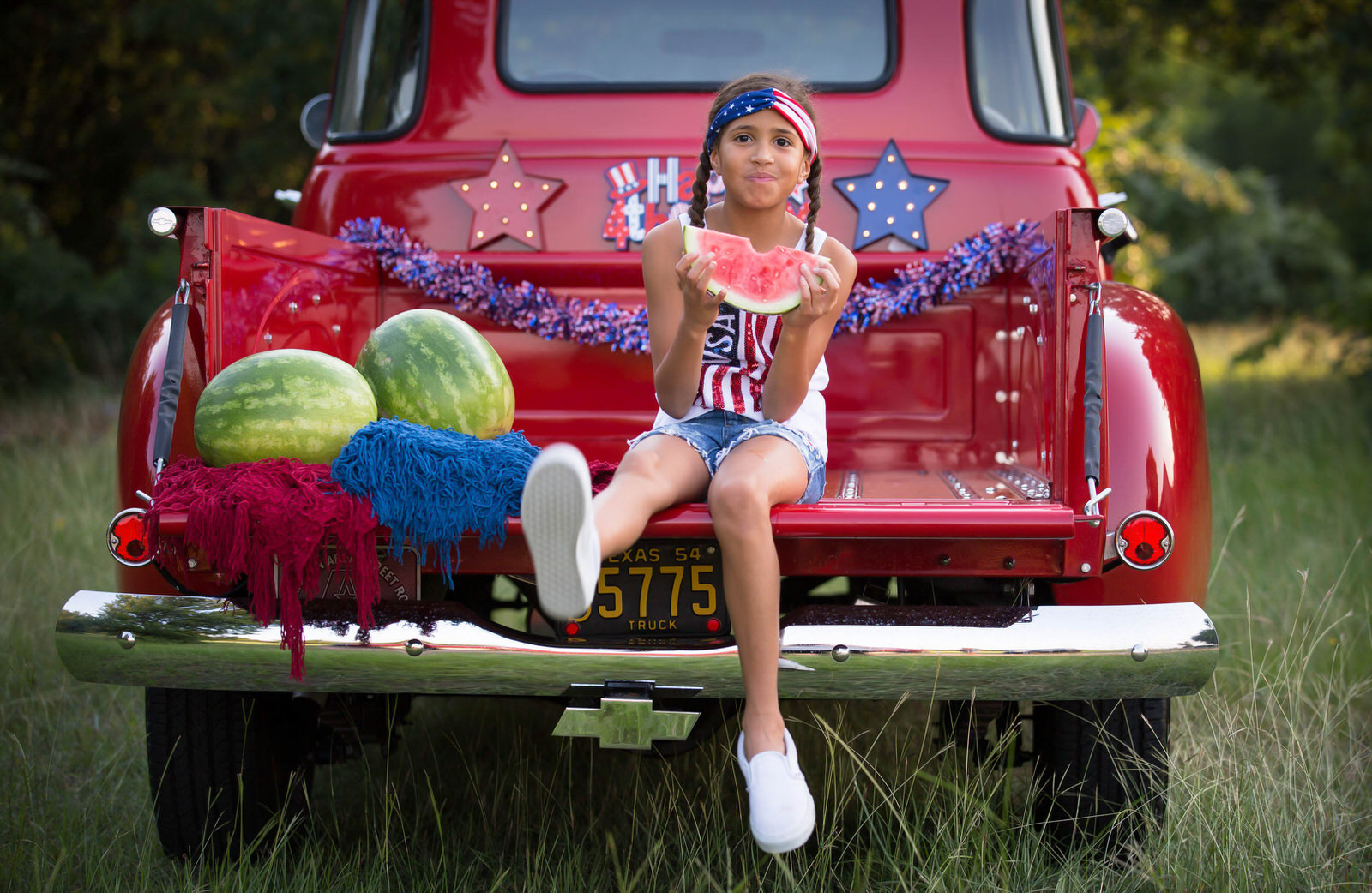 Girl in Vintage Red Truck eating watermelon 4th of July Photography