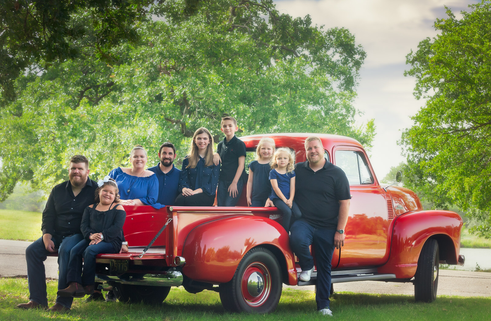 Family portrait in bed of Vintage Red Truck