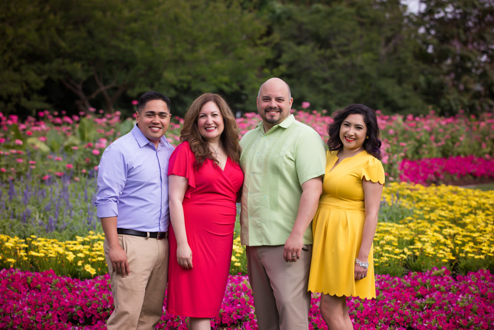 Family posing among wildflowers for bluebonnet and wildflower photography session